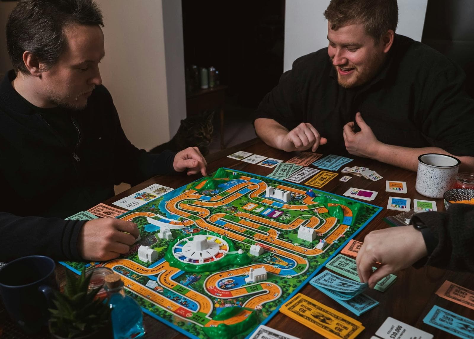 Friends mid-game around a board game on a café table