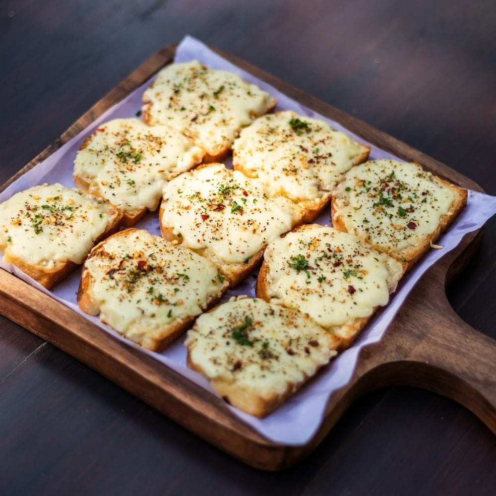 Chilli cheese toasts on a wooden tray