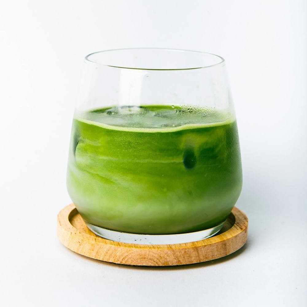 Bright green matcha coconut cooler in a glass