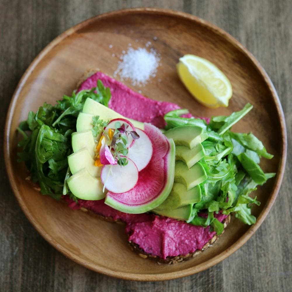 Avocado smash toast with greens and lime