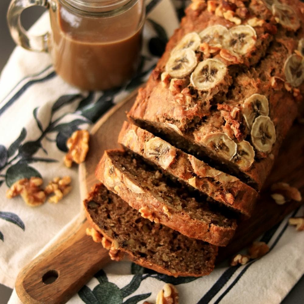 Sliced banana walnut bread on a board