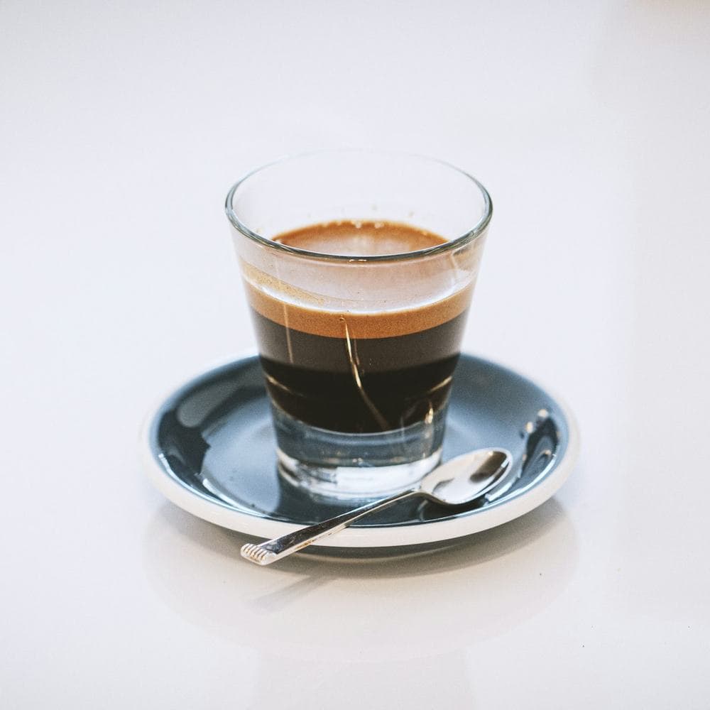 Cortado in a small glass on a saucer