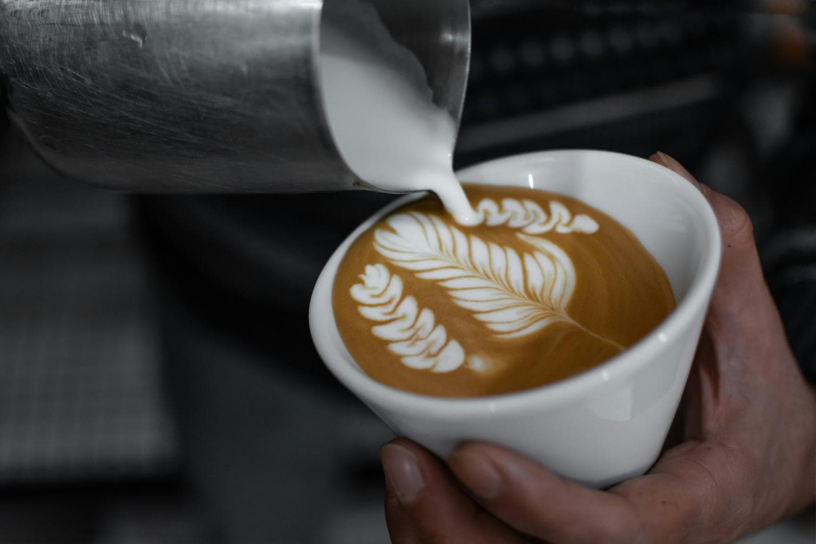 Cappuccino with a tulip of latte art, seen up close