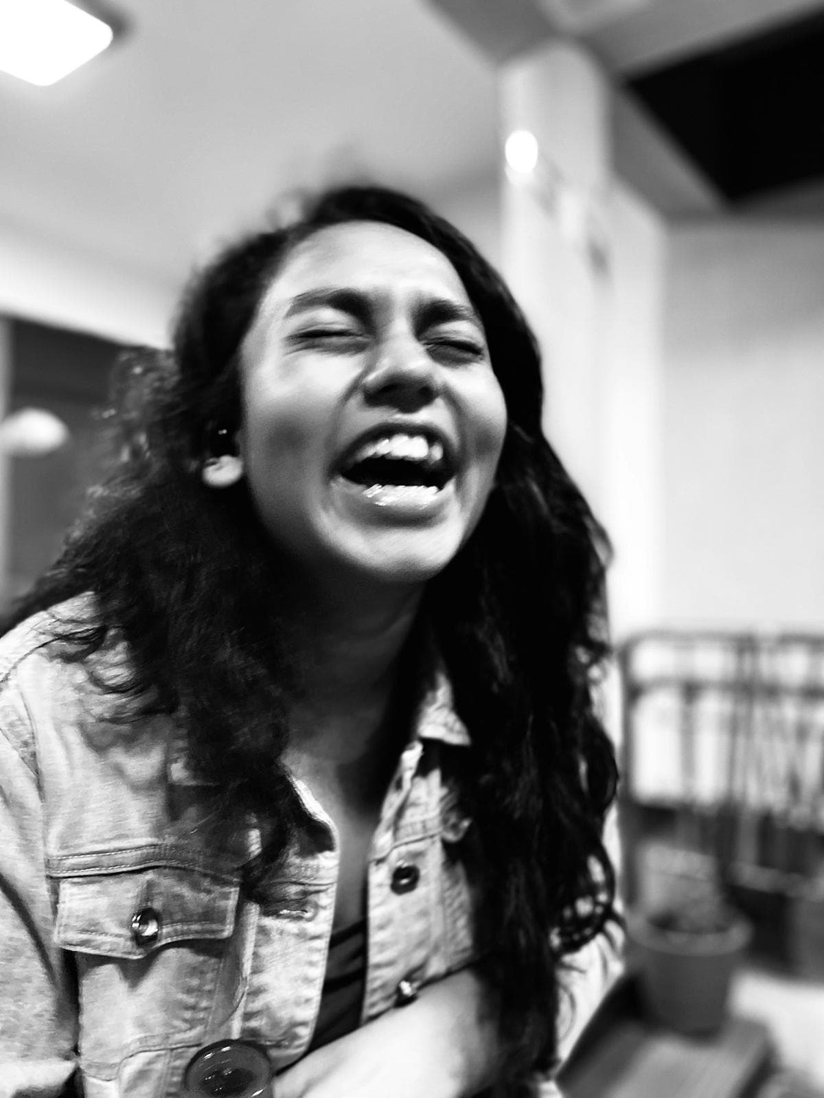 Woman laughing with her head thrown back